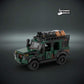 Lego scale model - custom military vehicle in army camouflage color with custom UV printed parts on a dark background with 'The Defender Brick' logo.