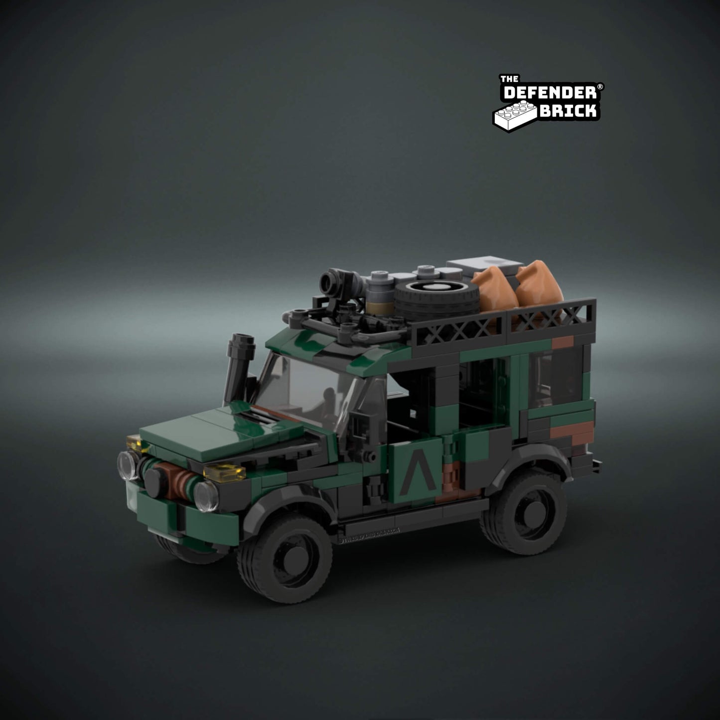 Lego scale model - custom military vehicle in army camouflage color with custom UV printed parts on a dark background with 'The Defender Brick' logo.