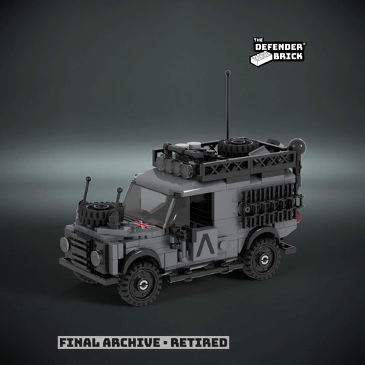 lego scale model military truck with urban warfare - grey livery and custom UV printed parts, on a dark background with 'The Defender Brick' branding.