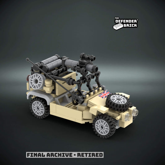 Custom Lego tactical vehicle in Desert tan color made of interlocking bricks with a custom UV printed British flag on a dark background, branded 'The Defender Brick'.